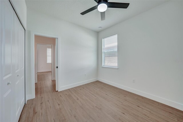 interior space with a closet, ceiling fan, and light hardwood / wood-style floors