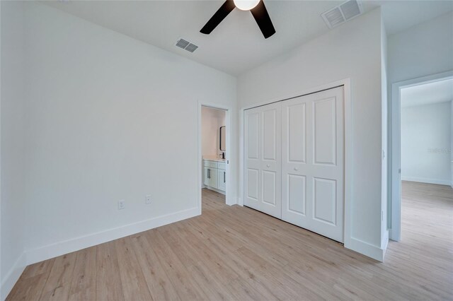 unfurnished bedroom featuring light hardwood / wood-style flooring, ceiling fan, and a closet