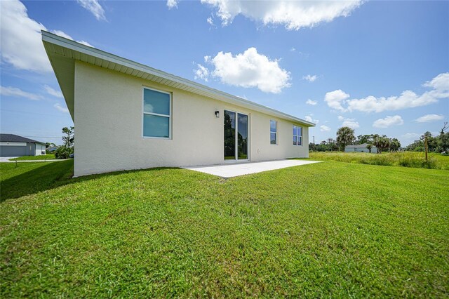 rear view of property with a patio area and a yard