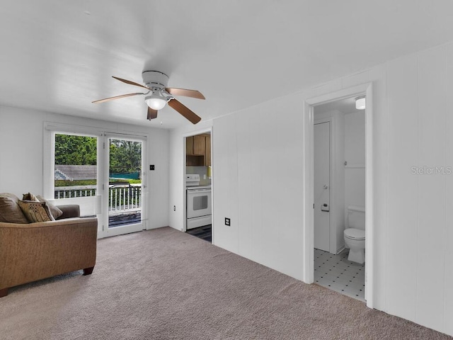 carpeted living room featuring ceiling fan