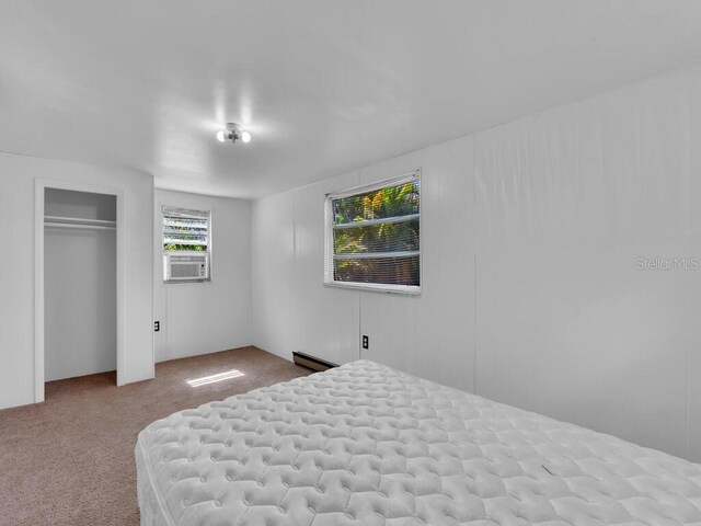 unfurnished bedroom featuring cooling unit and light carpet