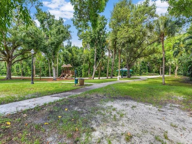 surrounding community with a playground and a lawn