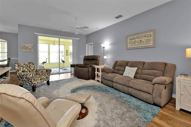 living room with hardwood / wood-style floors and ceiling fan