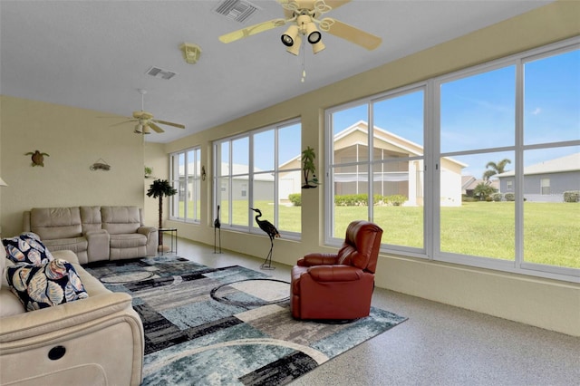 sunroom / solarium featuring plenty of natural light and ceiling fan