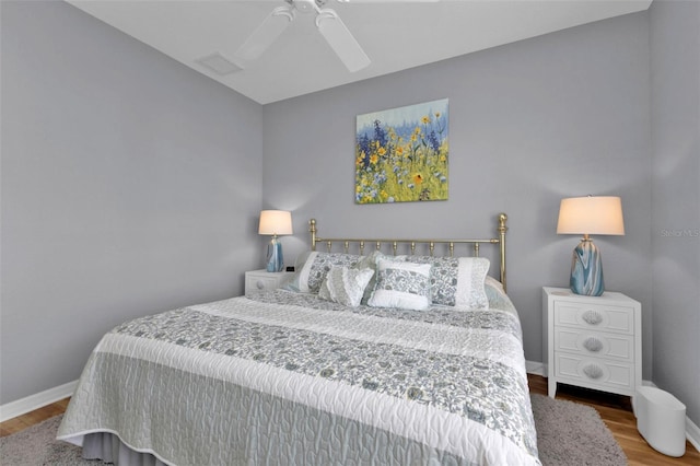 bedroom with hardwood / wood-style floors and ceiling fan