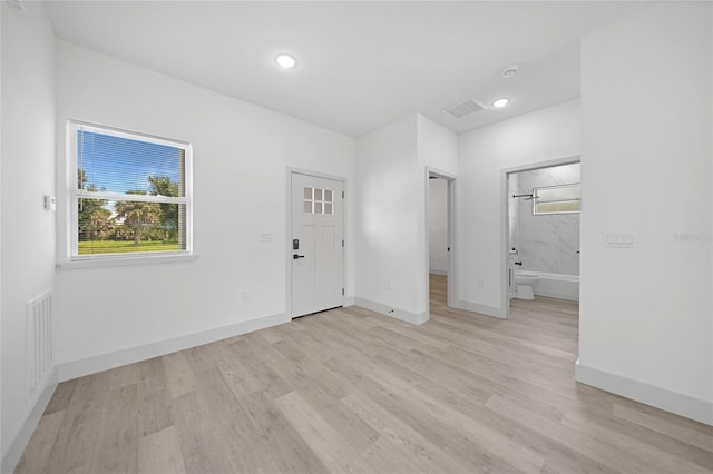 foyer featuring light wood-type flooring, visible vents, baseboards, and recessed lighting