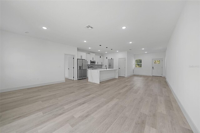 unfurnished living room featuring light hardwood / wood-style floors