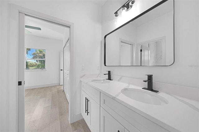 bathroom with ceiling fan, hardwood / wood-style flooring, and vanity