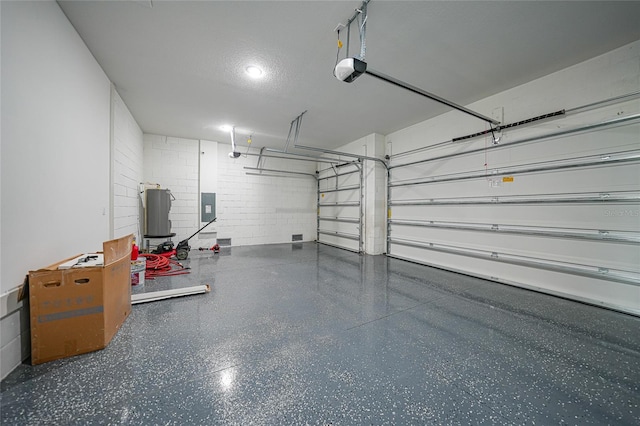 garage featuring electric panel, a garage door opener, and water heater