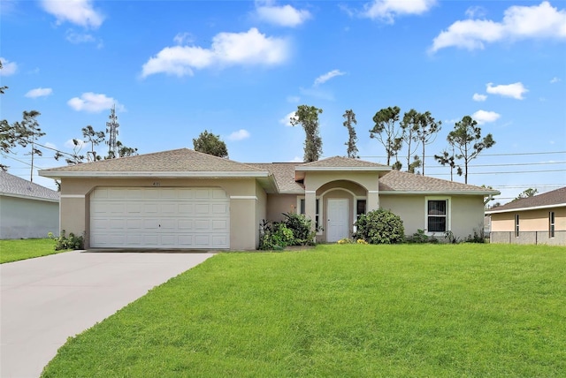 view of front of property with a garage and a front yard