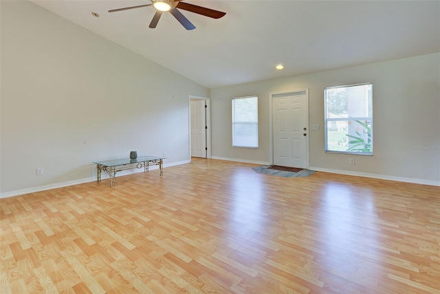 interior space with ceiling fan, light hardwood / wood-style floors, and vaulted ceiling