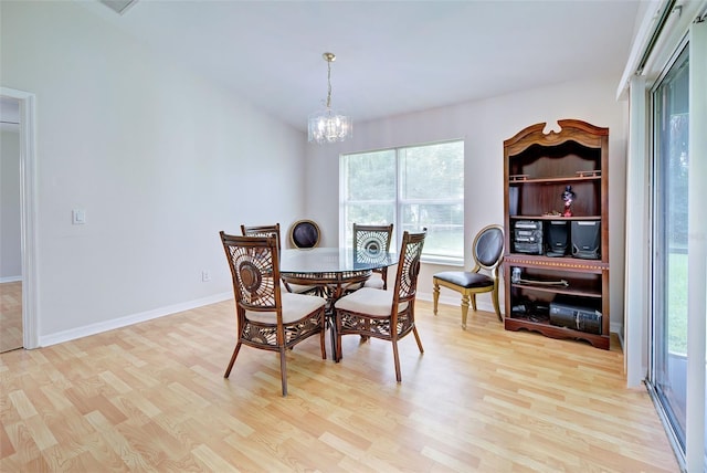 dining area featuring an inviting chandelier and light hardwood / wood-style floors