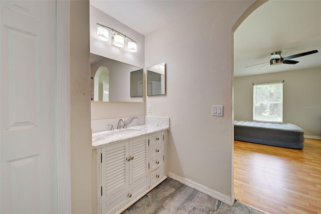 bathroom with vanity, ceiling fan, and wood-type flooring