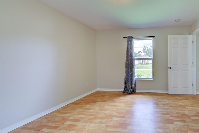 spare room featuring light hardwood / wood-style flooring