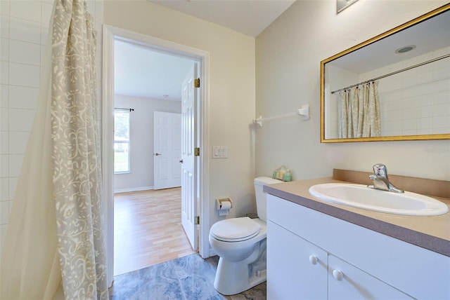 bathroom featuring vanity, toilet, and hardwood / wood-style flooring