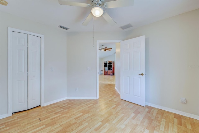 unfurnished bedroom featuring a closet, ceiling fan, and light hardwood / wood-style flooring