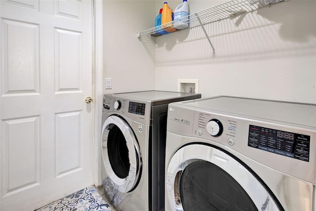 clothes washing area featuring washing machine and clothes dryer