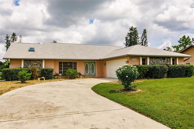 single story home with a garage and a front yard