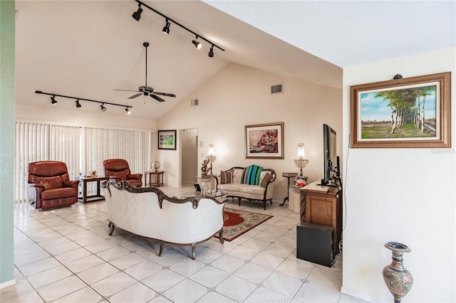 tiled living room featuring track lighting, vaulted ceiling, a healthy amount of sunlight, and ceiling fan