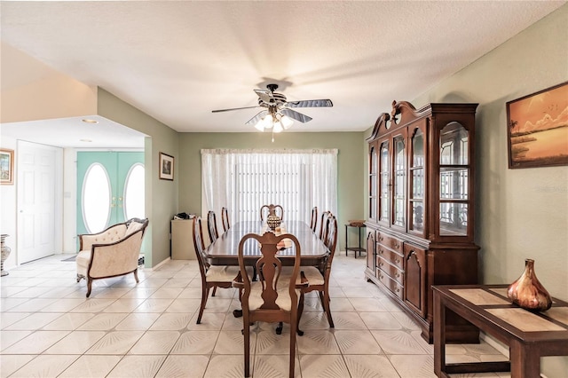 dining space with a textured ceiling and ceiling fan