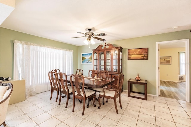 dining area featuring ceiling fan and light tile patterned floors