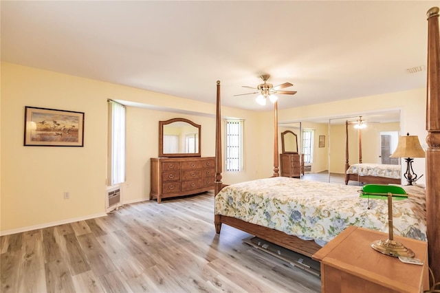 bedroom with light wood-type flooring, multiple windows, and ceiling fan