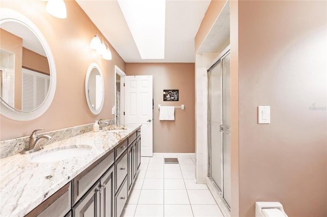 bathroom with vanity, tile patterned flooring, and a shower with door