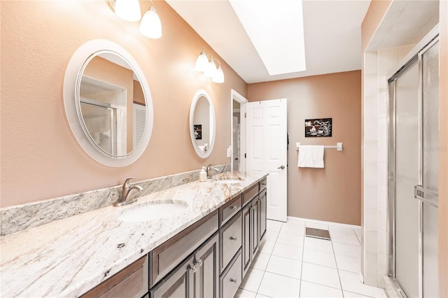 bathroom featuring a shower with shower door, tile patterned flooring, a skylight, and vanity