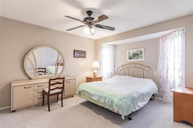 bedroom with ceiling fan and light carpet