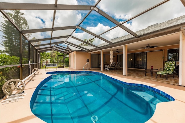 view of pool featuring ceiling fan, a patio, and glass enclosure