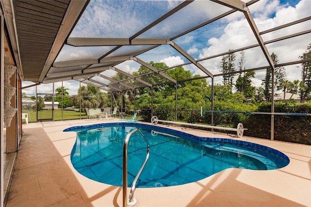 view of pool featuring a patio and glass enclosure