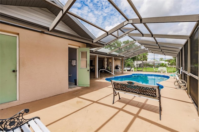 view of swimming pool with a lanai and a patio