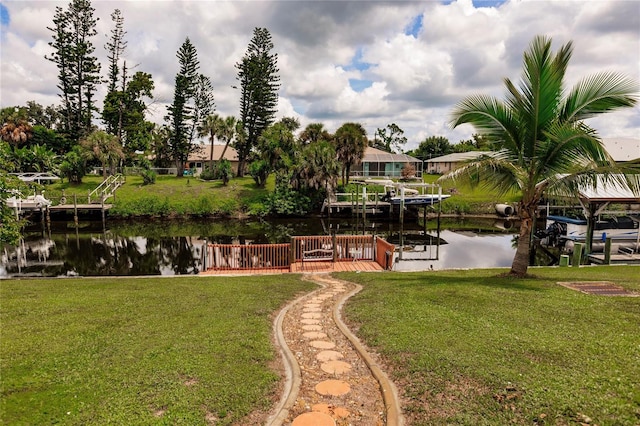 view of yard featuring a boat dock and a water view