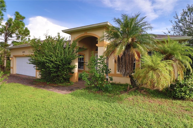 view of front of property featuring a garage and a front yard