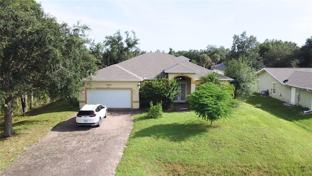 view of front facade featuring a garage and a front lawn