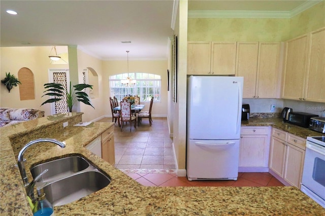 kitchen with decorative light fixtures, white appliances, light stone countertops, light tile patterned floors, and sink