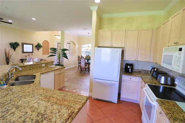 kitchen featuring stone countertops, white appliances, light tile patterned floors, and sink