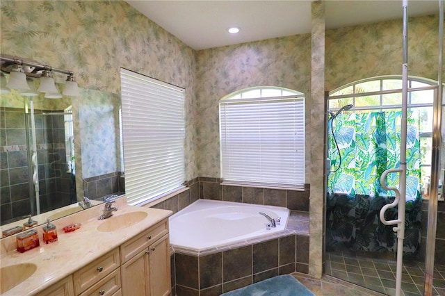 bathroom with vanity and independent shower and bath