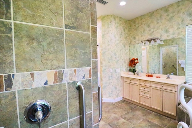 bathroom with a shower and vanity