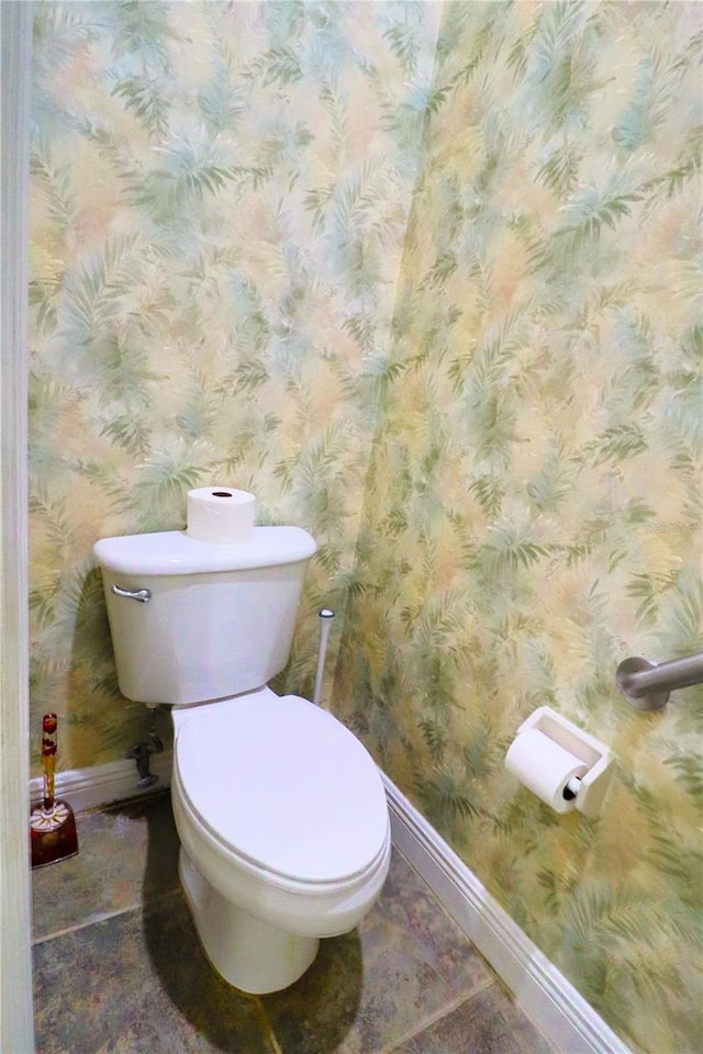 bathroom with toilet and tile patterned floors