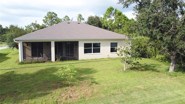 back of house featuring a yard and a sunroom