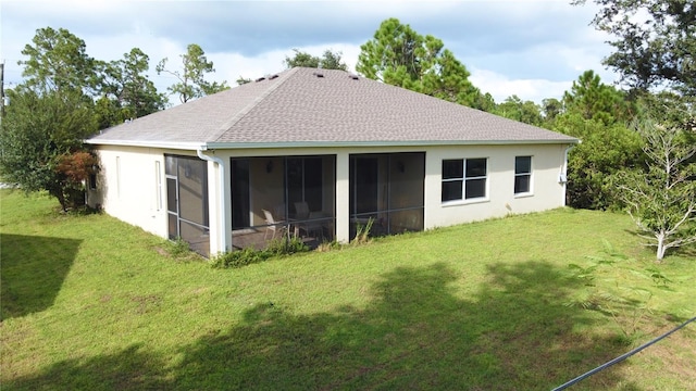 rear view of property with a sunroom and a lawn