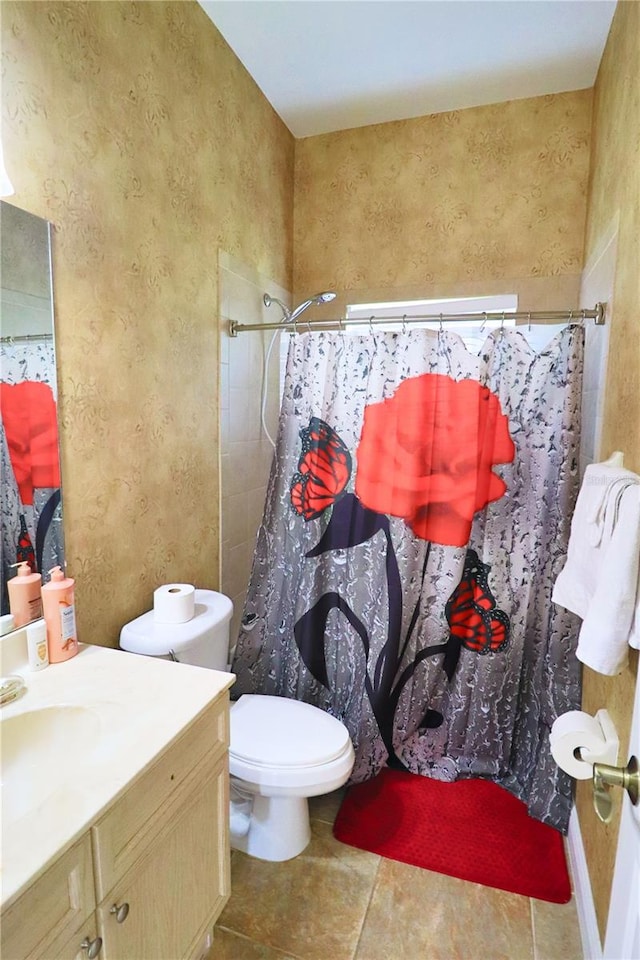 bathroom featuring vanity, toilet, walk in shower, and tile patterned floors