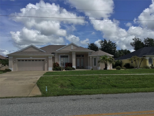 view of front of house with a garage and a front yard