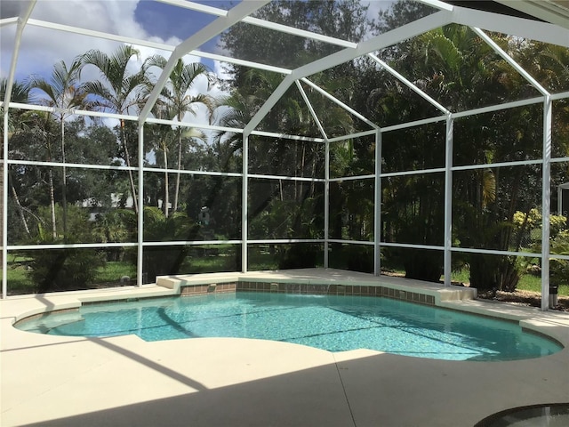 view of pool featuring a patio area and a lanai