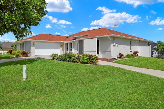 ranch-style house with stucco siding, an attached garage, fence, driveway, and a front lawn