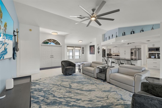 tiled living room featuring lofted ceiling and ceiling fan