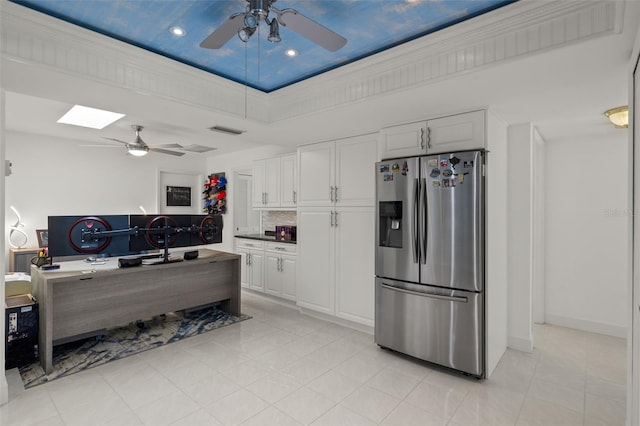 kitchen with ceiling fan, stainless steel fridge, white cabinets, and light tile patterned flooring