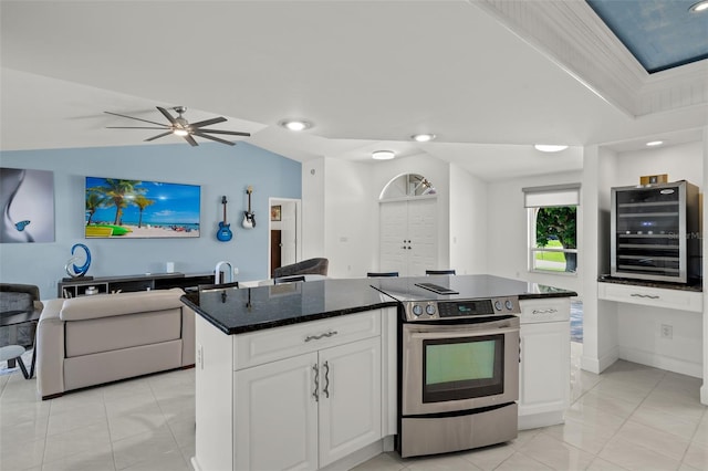 kitchen featuring stainless steel range with electric stovetop, white cabinetry, a kitchen island, and wine cooler