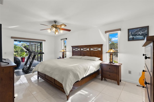 bedroom featuring multiple windows, light tile patterned floors, and ceiling fan